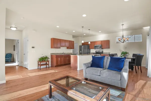 a living room with furniture and kitchen view