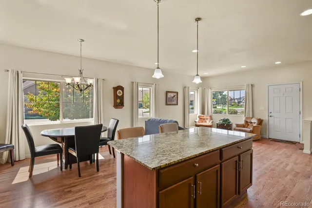 a dining table with chairs and wooden floor