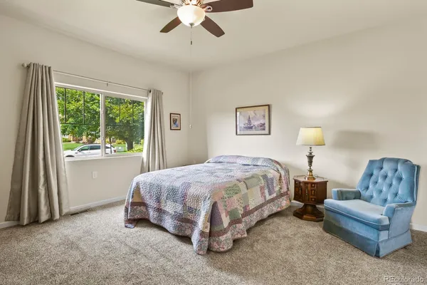 a spacious bedroom with a bed and a couch