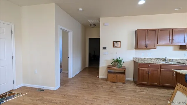 a kitchen with kitchen island granite countertop wooden cabinets and stainless steel appliances