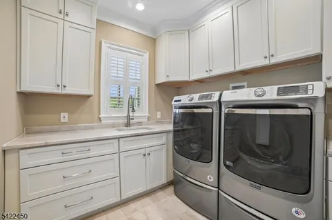 a kitchen with granite countertop white cabinets and stainless steel appliances