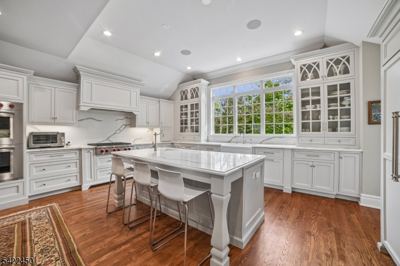 74 Noe Avenue Madison, NJ 07940 - Photo 5 of 27 a kitchen with granite countertop a stove a sink dishwasher and a refrigerator with wooden floor