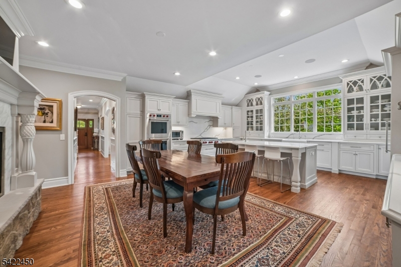 74 Noe Avenue Madison, NJ 07940 - Photo 7 of 27 a dining hall with stainless steel appliances granite countertop a stove a couches table and chairs