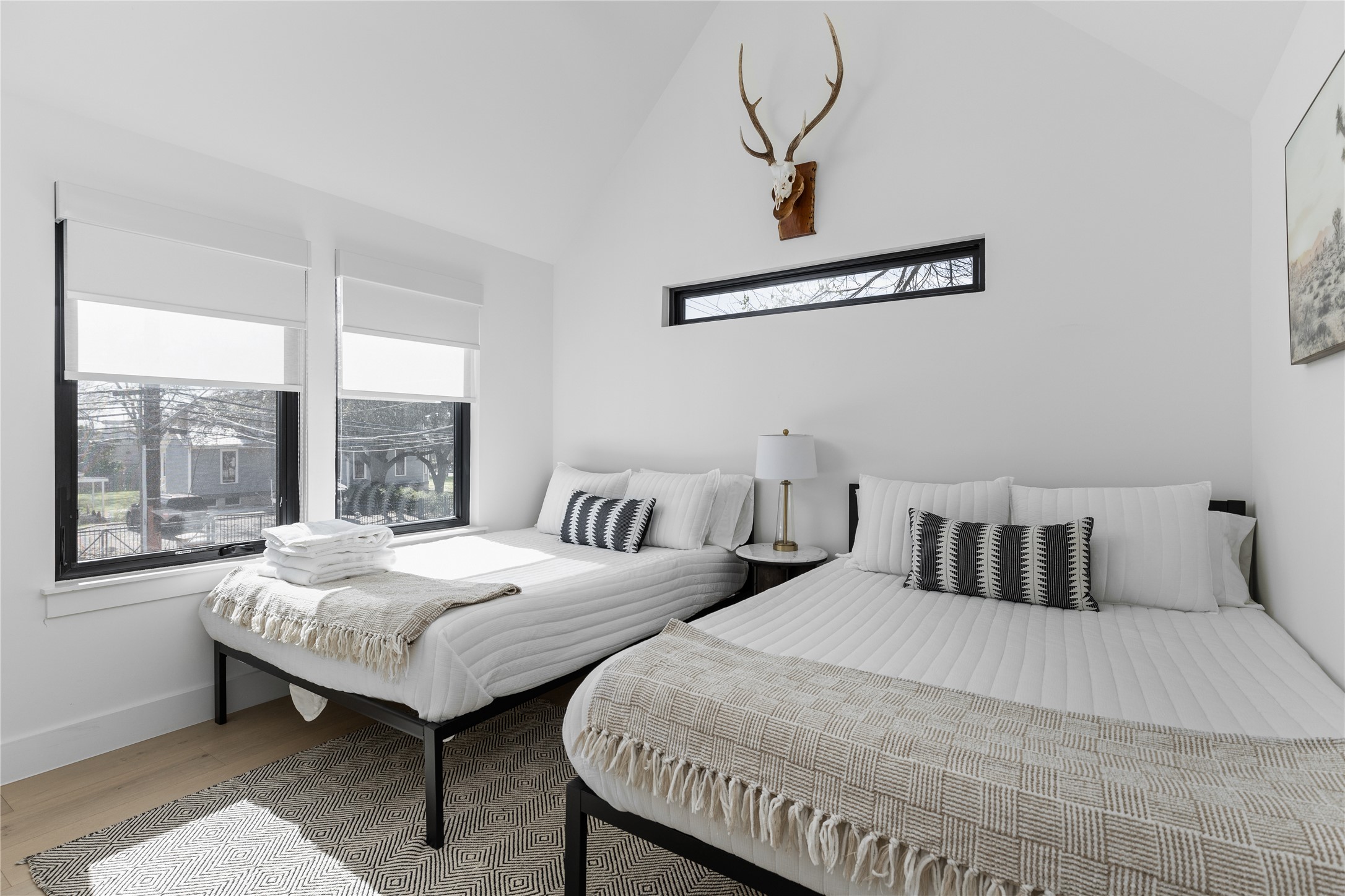 108 Comal Street Austin, TX 78702 - Photo 23 of 40 Bedroom featuring vaulted ceiling, multiple windows, and wood finished floors