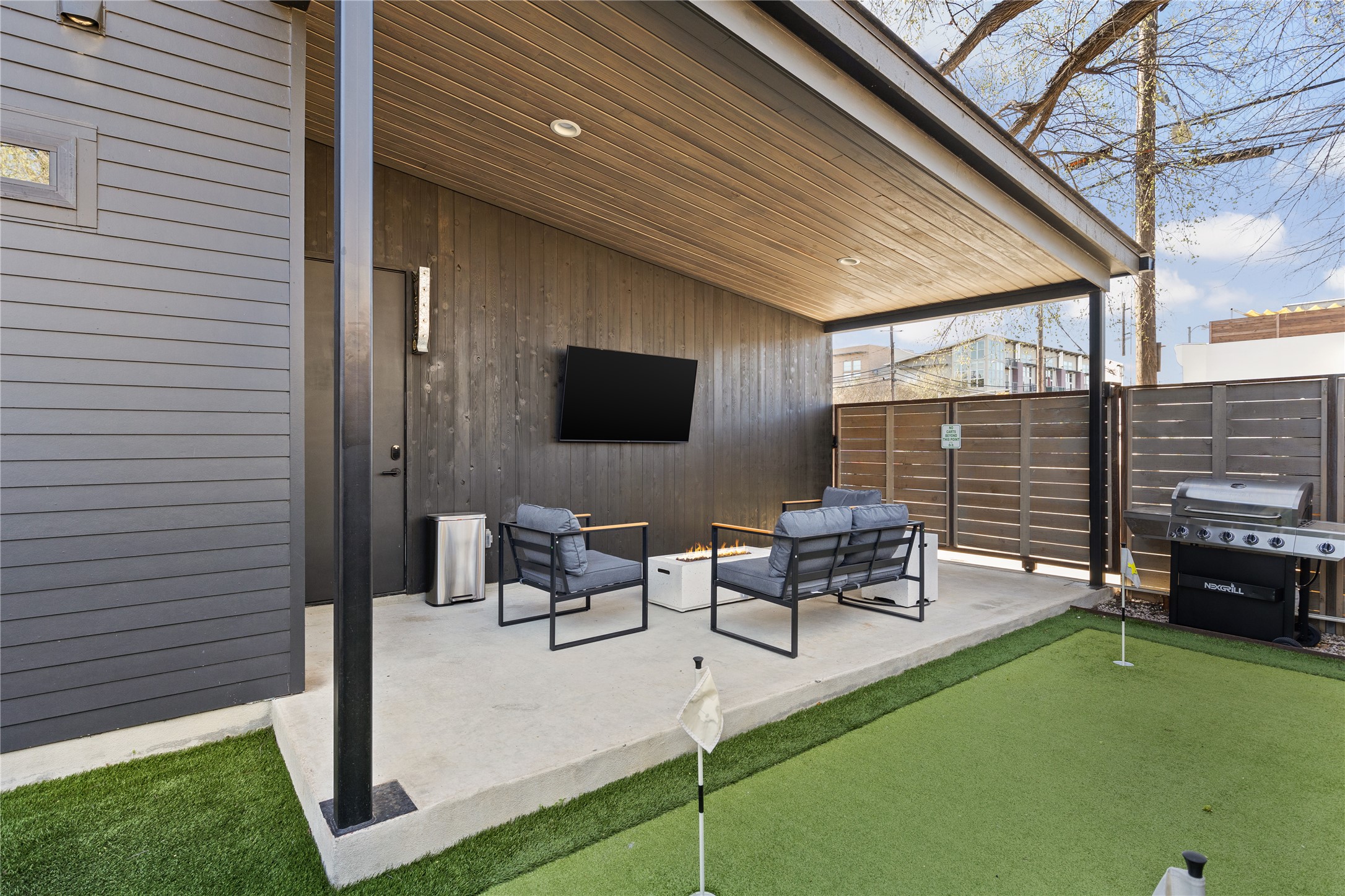 108 Comal Street Austin, TX 78702 - Photo 34 of 40 a view of a patio with table and chairs potted plants with wooden fence