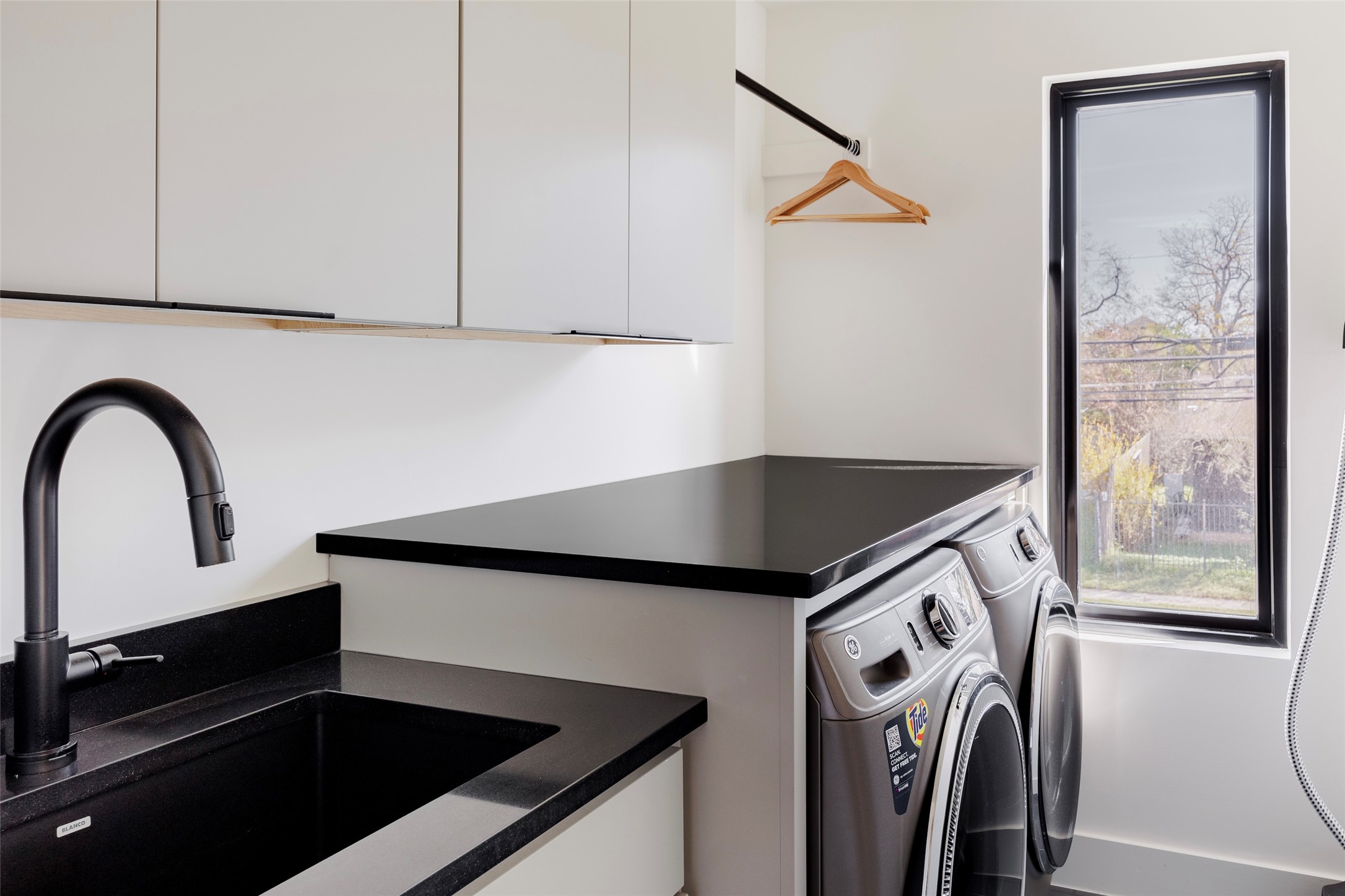 108 Comal Street Austin, TX 78702 - Photo 40 of 40 Laundry room featuring washer and clothes dryer and cabinet space