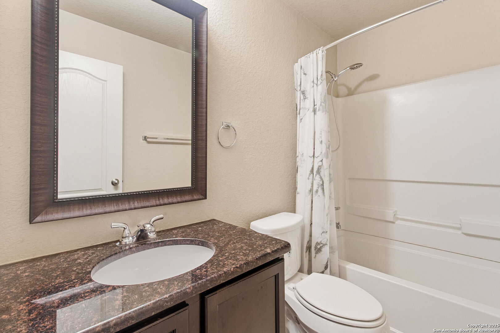 8806 Atwater Creek San Antonio, TX 78245 - Photo 13 of 16 a bathroom with a granite countertop sink toilet mirror and shower