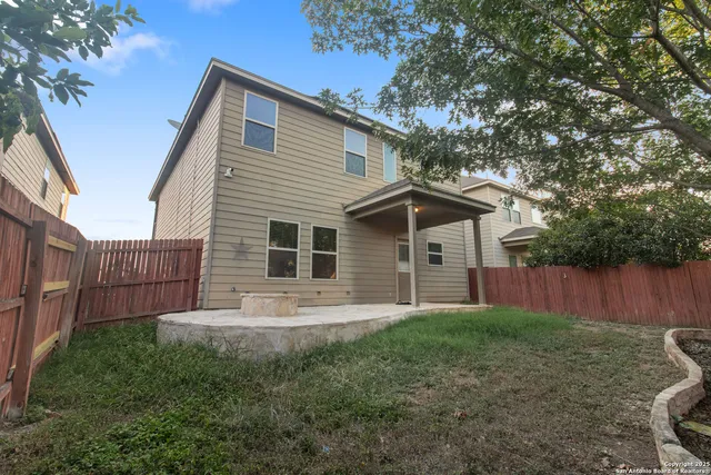 a front view of house with a garden and yard