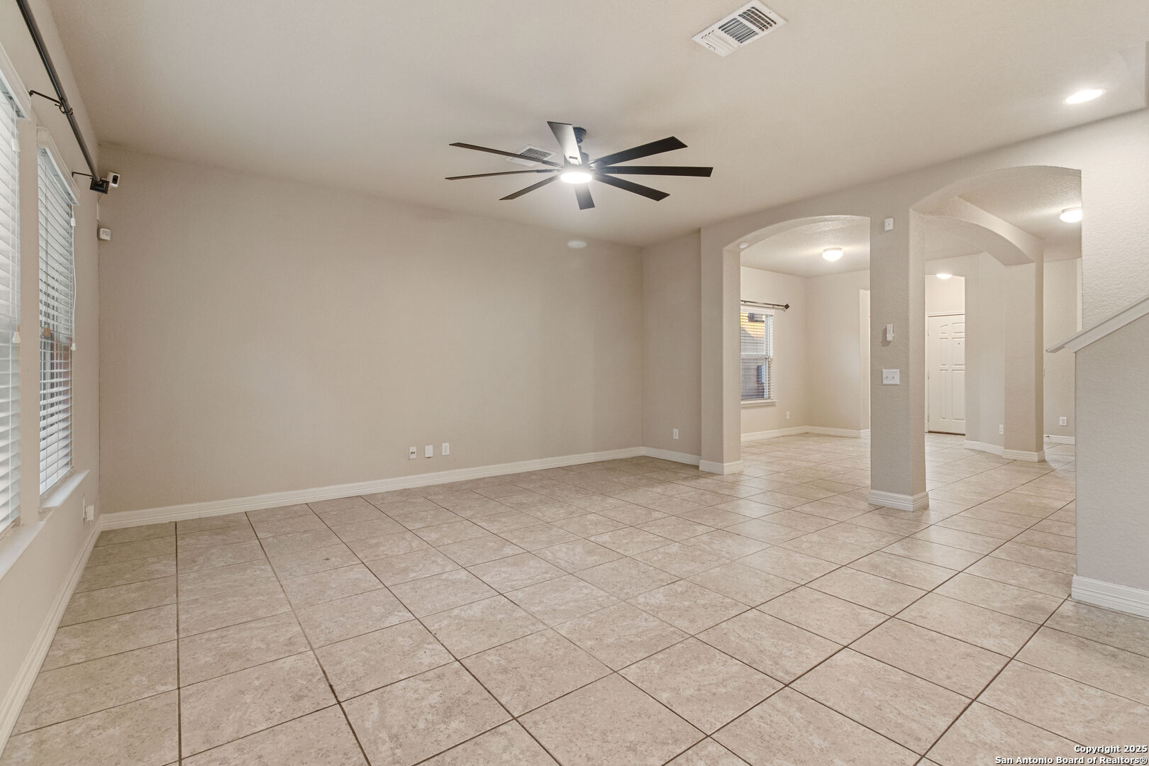 8806 Atwater Creek San Antonio, TX 78245 - Photo 8 of 16 en empty room with white walls and ceiling fan