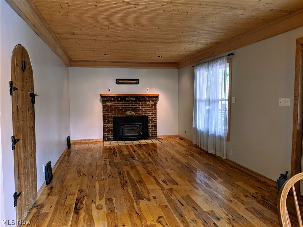4034 Riblett Road Youngstown, OH 44515 - Photo 4 of 26 Living room includes wood fireplace and hard wood floor.