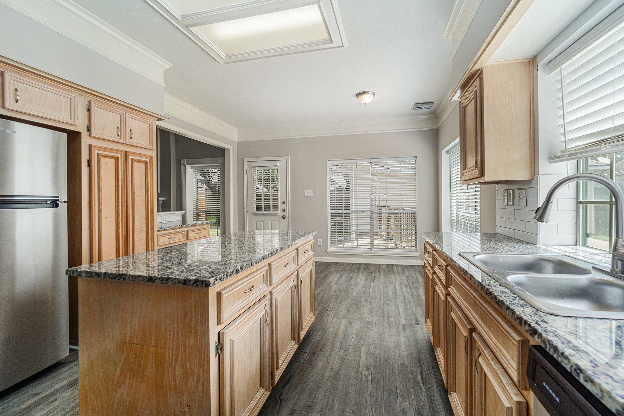 15906 Marwick Court Houston, TX 77095 - Photo 11 of 23 a kitchen with stainless steel appliances granite countertop a sink stove and refrigerator