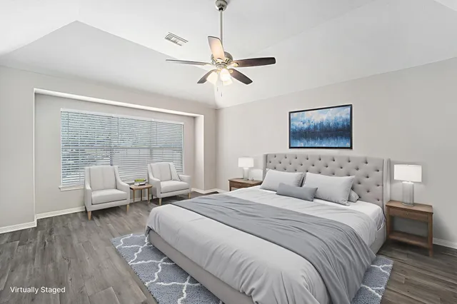 a bedroom with double bed and a large window