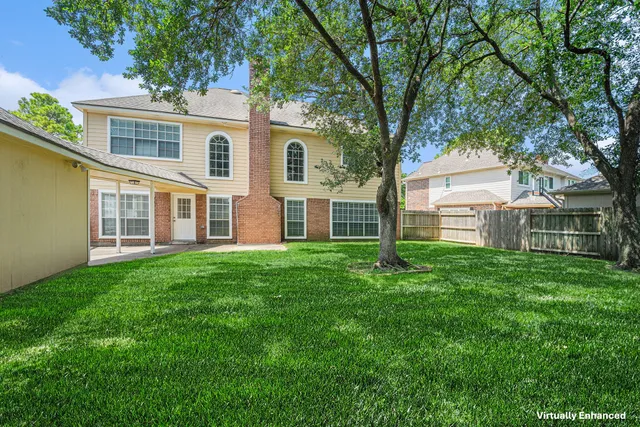 a view of a house with yard and tree s