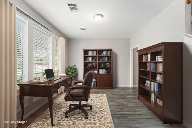 a view of a workspace with furniture and a bookshelf