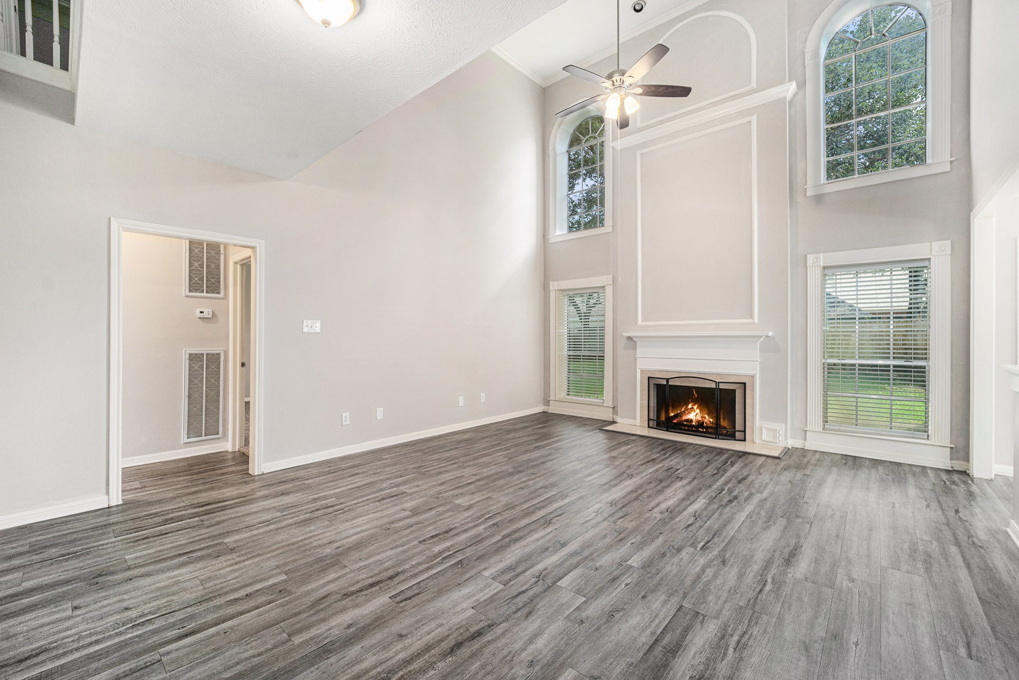 15906 Marwick Court Houston, TX 77095 - Photo 8 of 23 a view of an empty room with wooden floor fireplace and a window