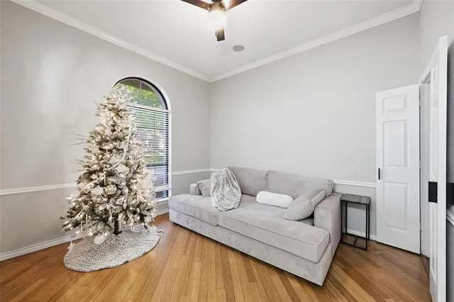 a living room with furniture flowerpot and wooden floor