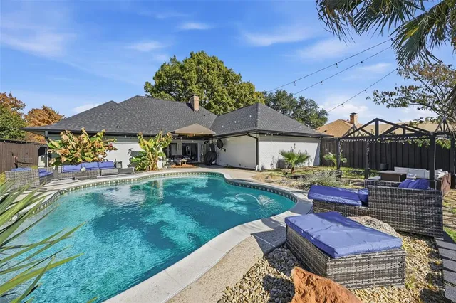 a backyard of a house with table and chairs