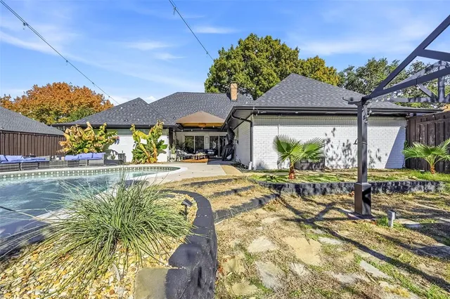 a view of a house with swimming pool and a yard