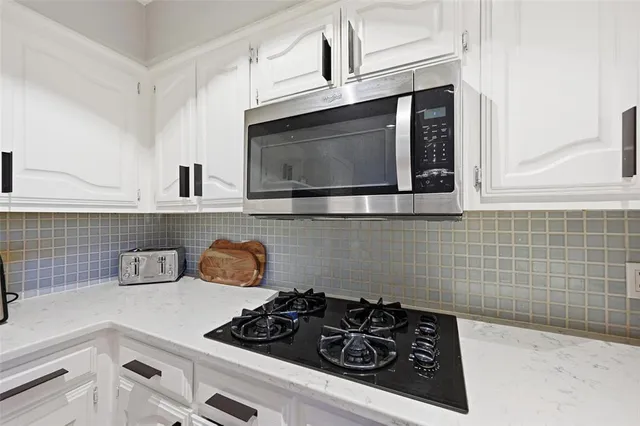 a kitchen with a stove and cabinets