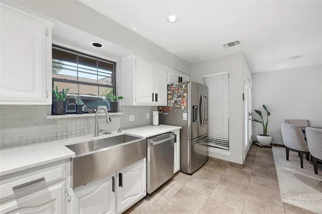 a kitchen with a sink cabinets and window