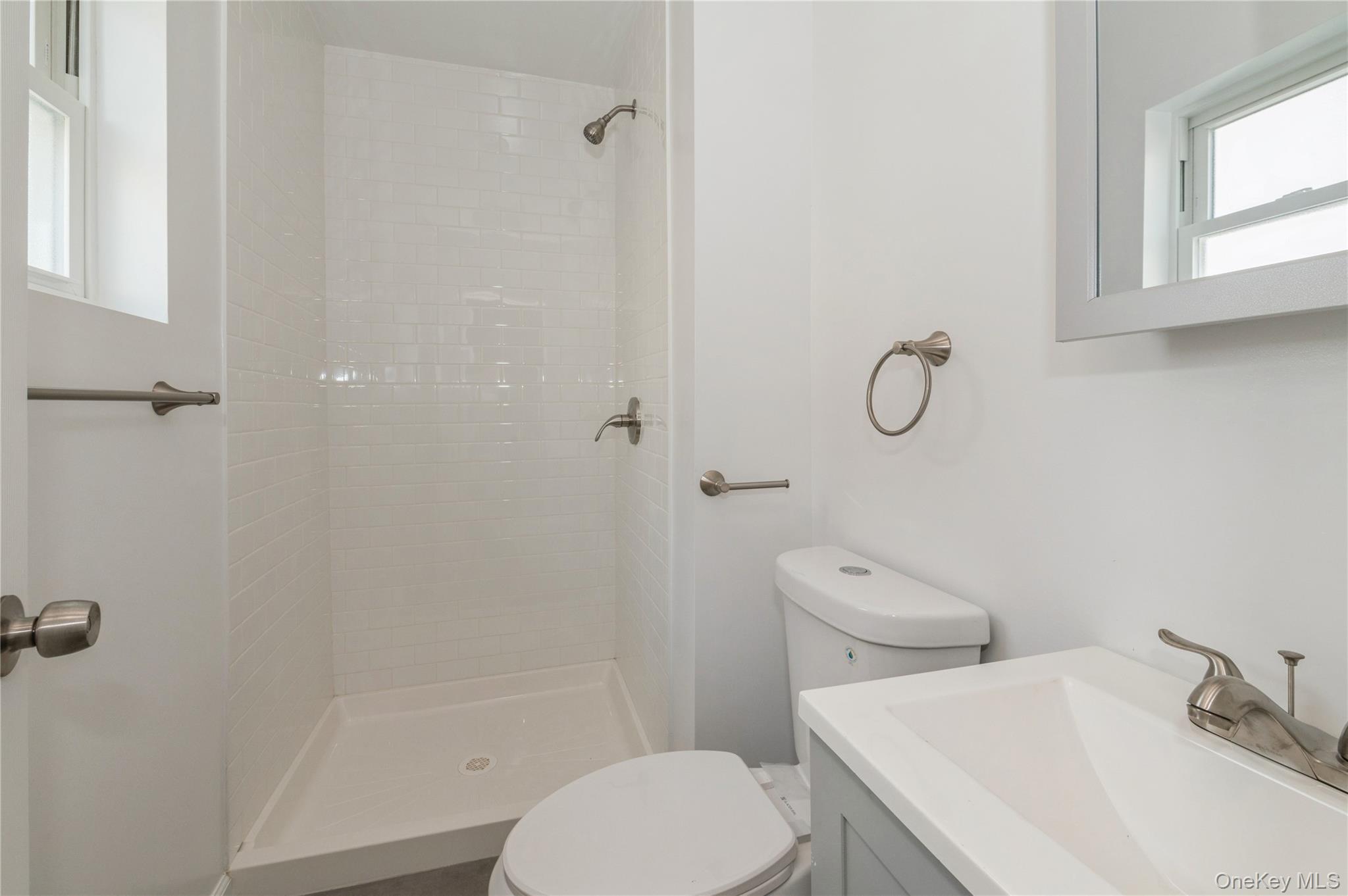 216-23 136th Road Queens, NY 11413 - Photo 14 of 28 Full bath with plenty of natural light, a shower stall, and vanity