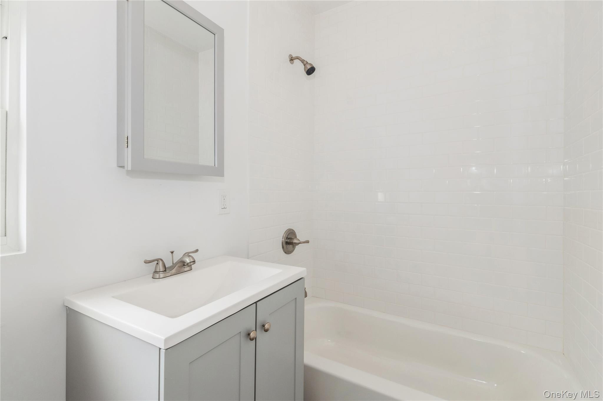 216-23 136th Road Queens, NY 11413 - Photo 20 of 28 Bathroom featuring vanity and tub / shower combination