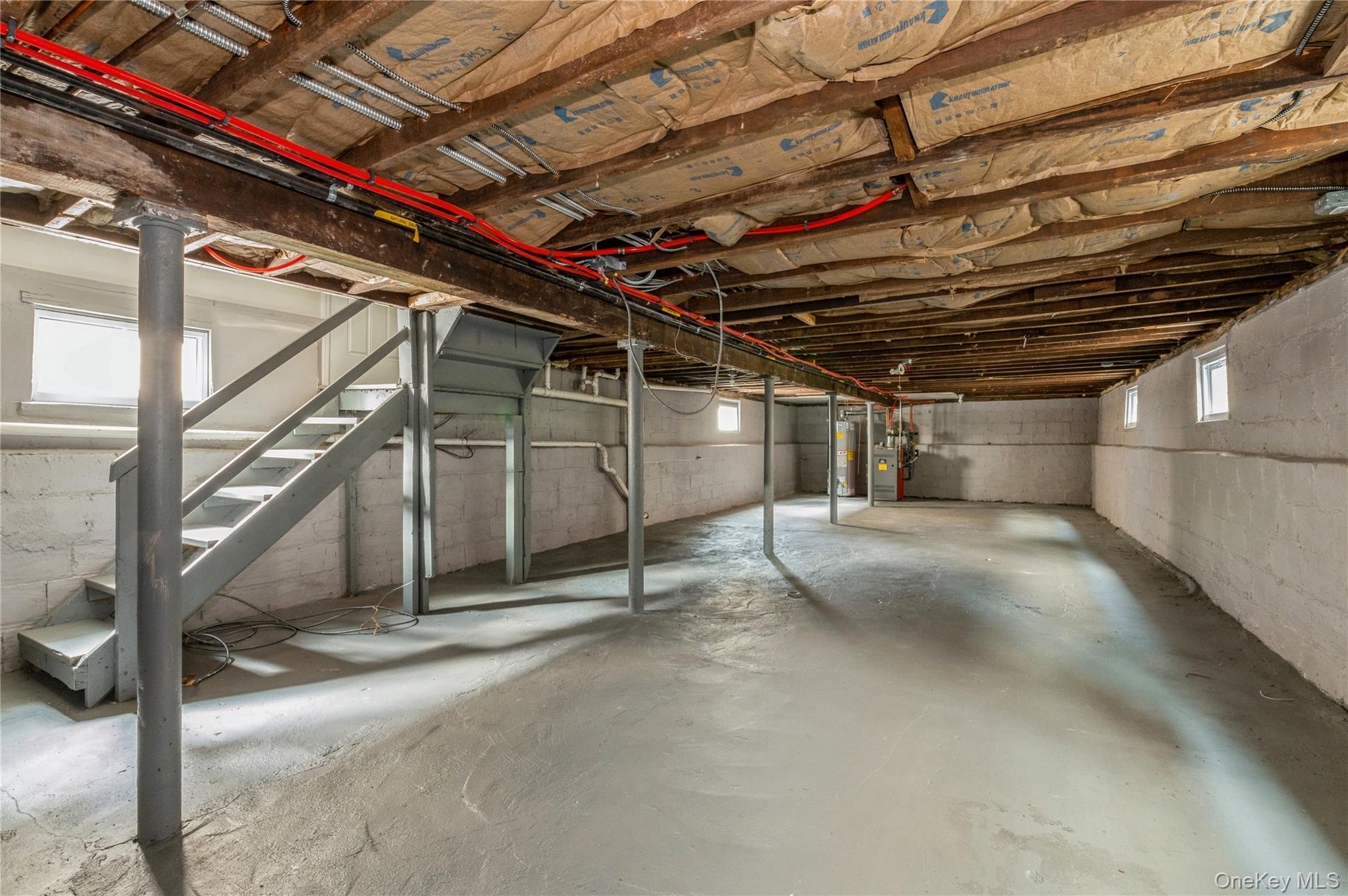 216-23 136th Road Queens, NY 11413 - Photo 24 of 28 Below grade area with stairs and gas water heater