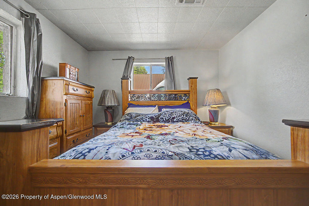 625 Russell Street Craig, CO 81625 - Photo 26 of 35 a bedroom with a bed and wooden floor