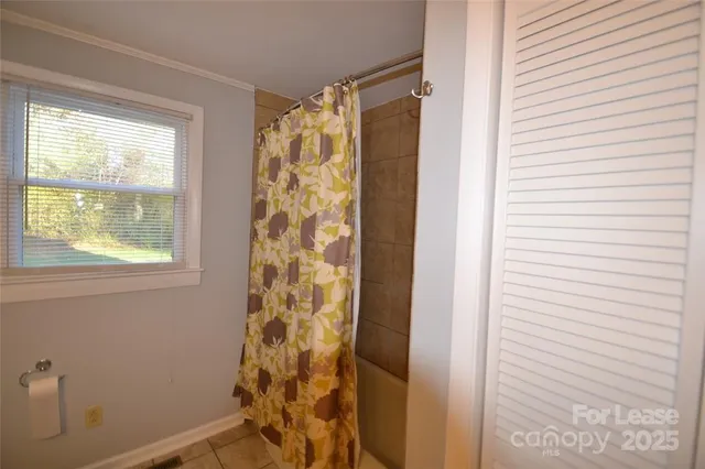 a bathroom with a shower and a window