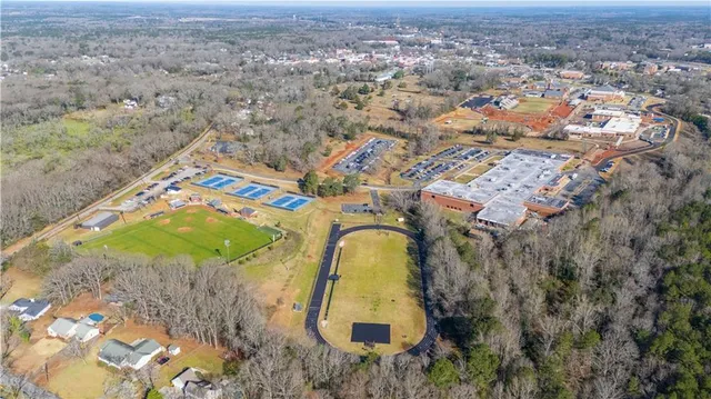 an aerial view of a house with a yard and ocean view