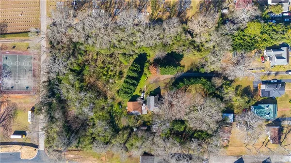 a backyard of a building with lots of trees