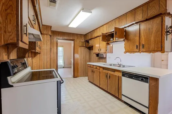 a kitchen that has a sink and a stove in it