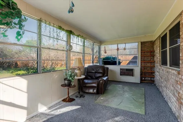 a living room with furniture a window and a flat screen tv