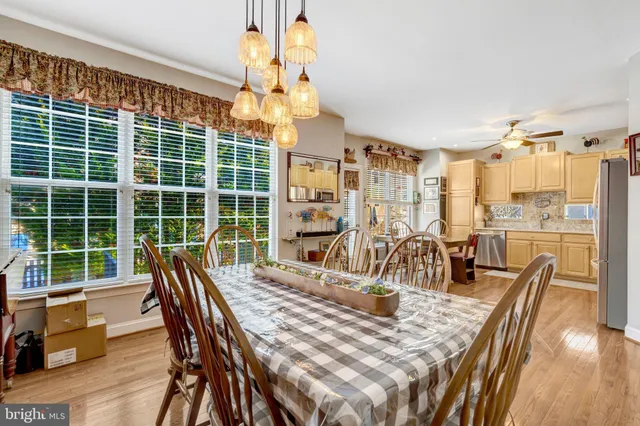 a view of a dining room with furniture a chandelier and wooden floor