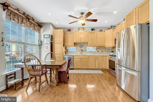 a kitchen with a table chairs refrigerator and cabinets