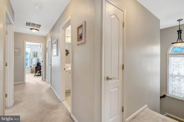 a view of a hallway with a livingroom and a dinning room