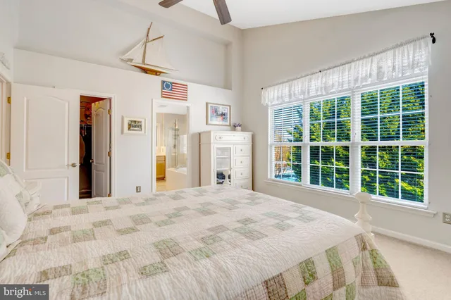 a bedroom with a large bed and a large window