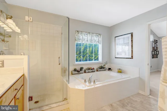 a bathroom with a tub sink and mirror