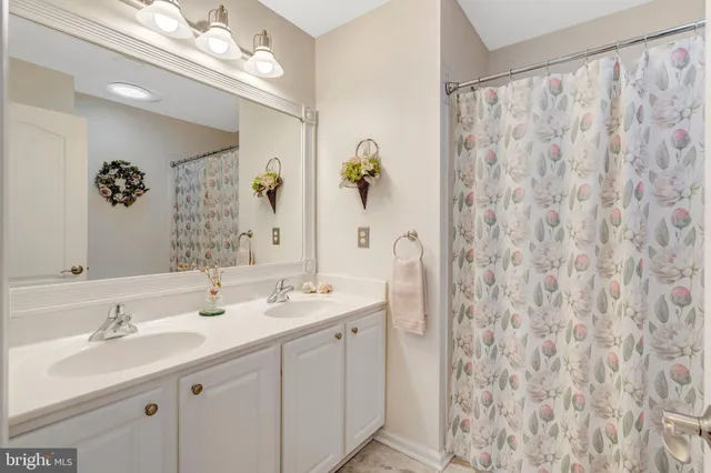 a bathroom with a double vanity sink and a mirror