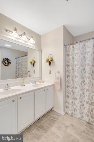 a spacious bathroom with a double vanity sink mirror and