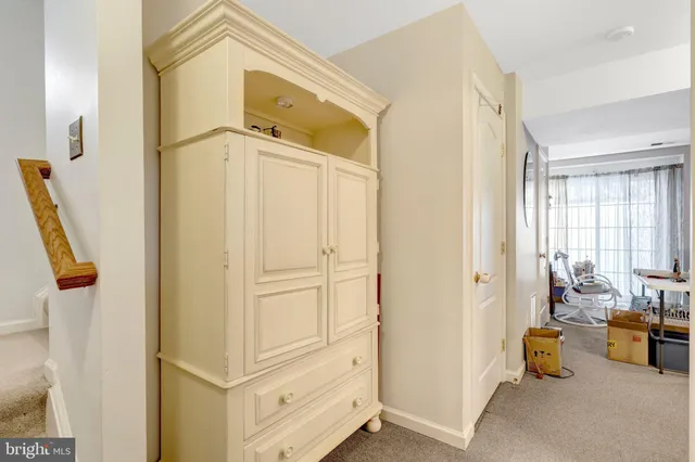 a view of hallway with livingroom and furniture