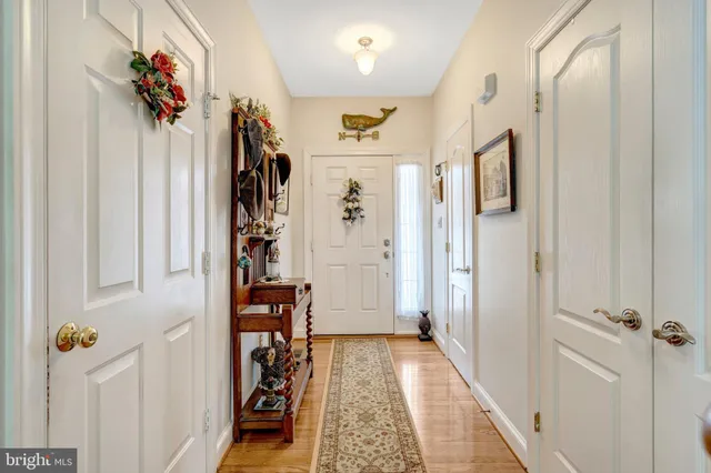 a view of a hallway with wooden floor and closet
