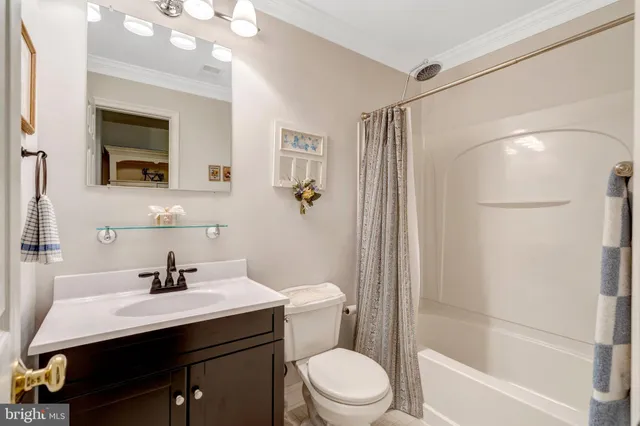 a bathroom with a sink a toilet a mirror and shower