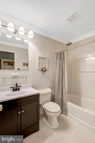a white toilet sitting next to a bathroom sink and a shower