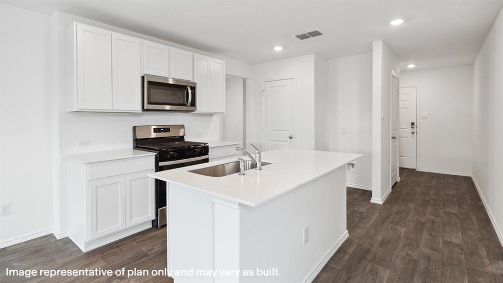 a kitchen with a sink stove and microwave