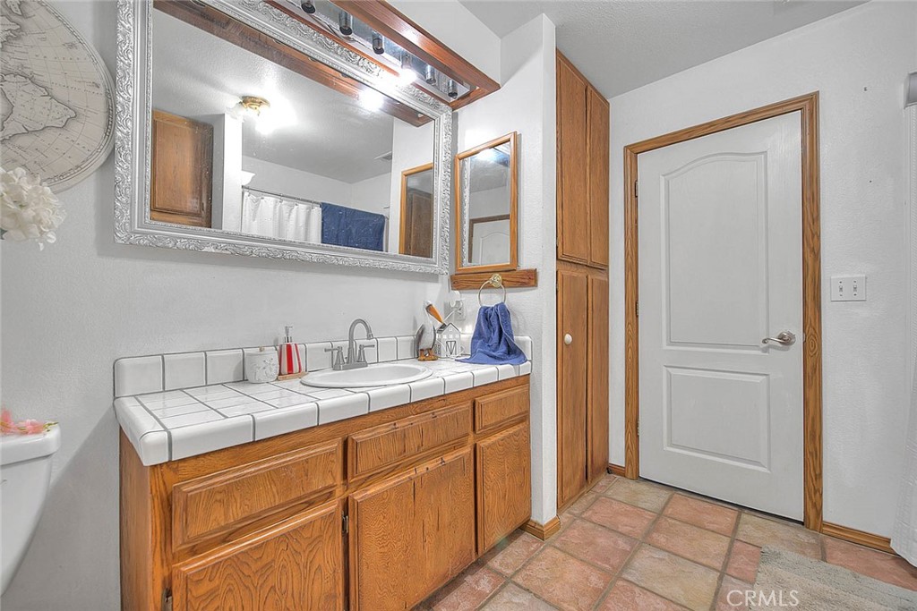 8529 Nielson Road Phelan, CA 92371 - Photo 23 of 44 a bathroom with a sink and a mirror