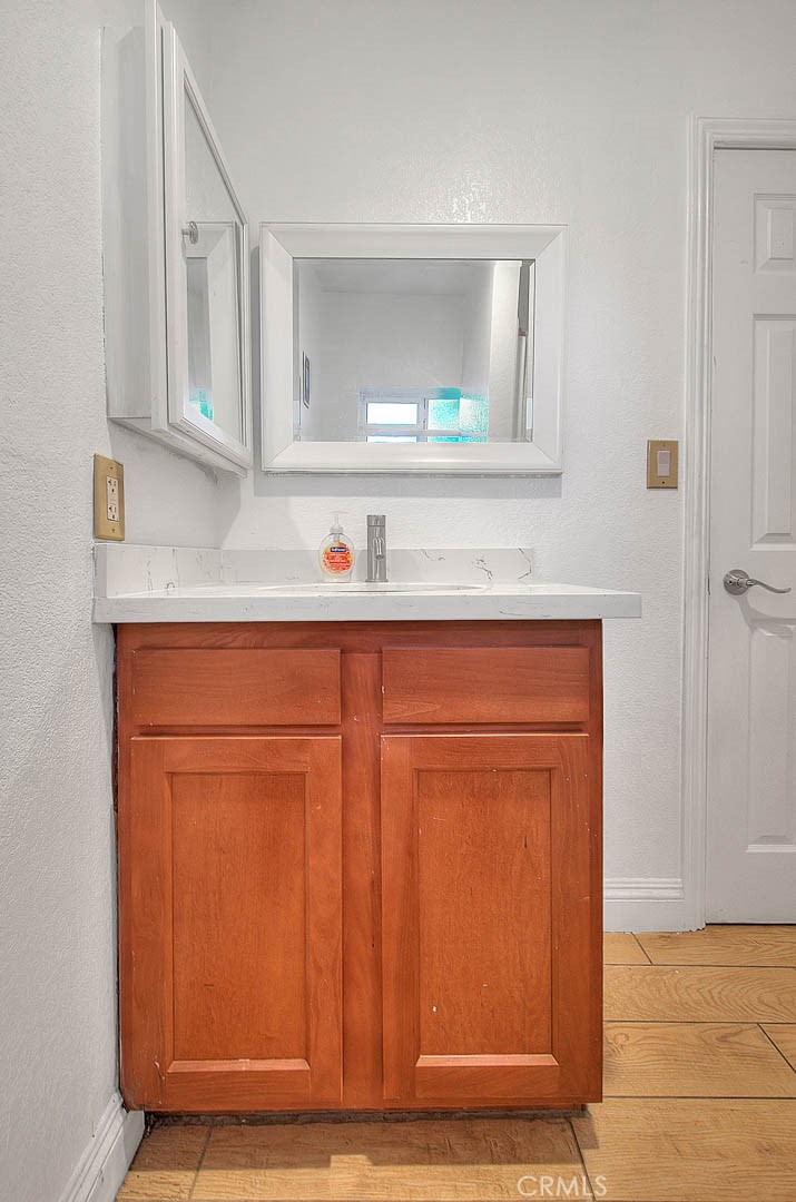 8529 Nielson Road Phelan, CA 92371 - Photo 38 of 44 a bathroom with a sink a mirror and cabinets
