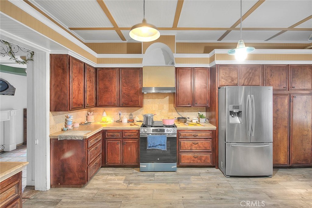 8529 Nielson Road Phelan, CA 92371 - Photo 9 of 44 a kitchen with granite countertop stainless steel appliances and wooden cabinets