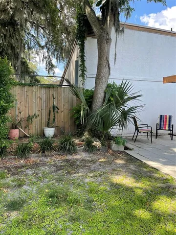 a backyard of a house with table and chairs