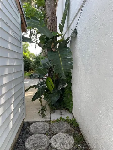 a backyard of a house with a garden and outdoor seating